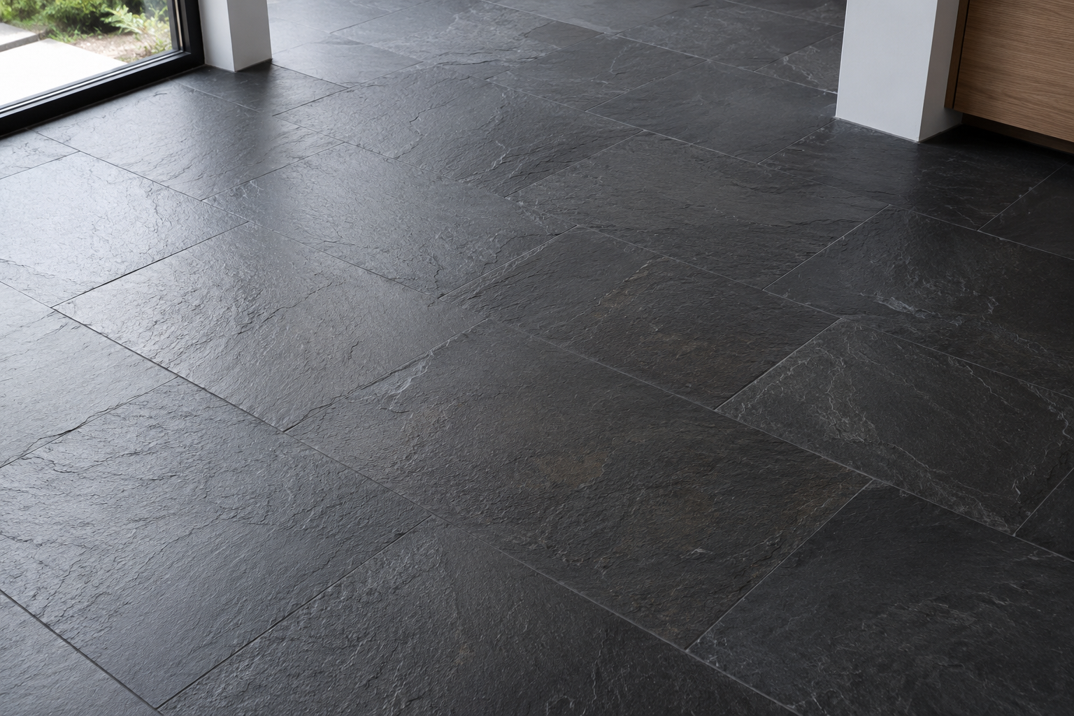Black slate floor tiles in a modern open-plan room